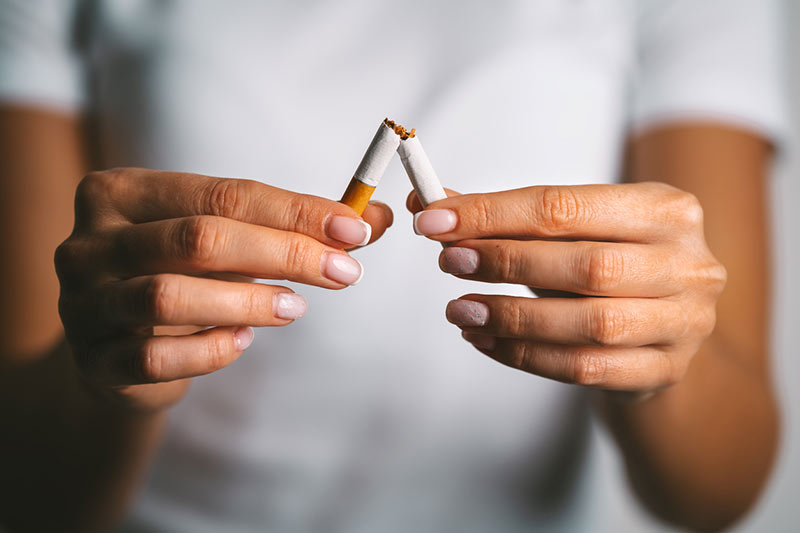 image of someone breaking a cigarette